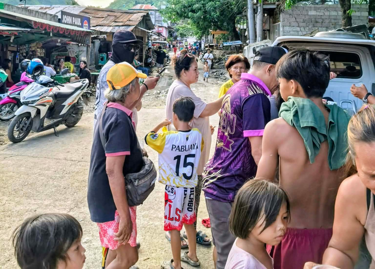Volunteers and families gathered during a neighbourhood outreach