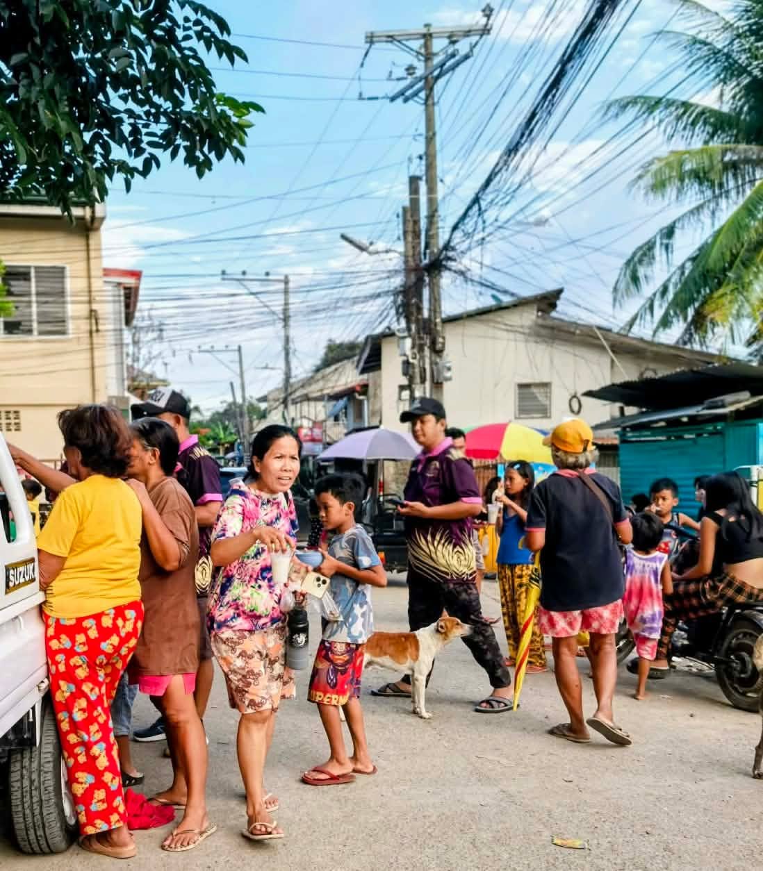 Residents and volunteers sharing food and drinks during a street outreach