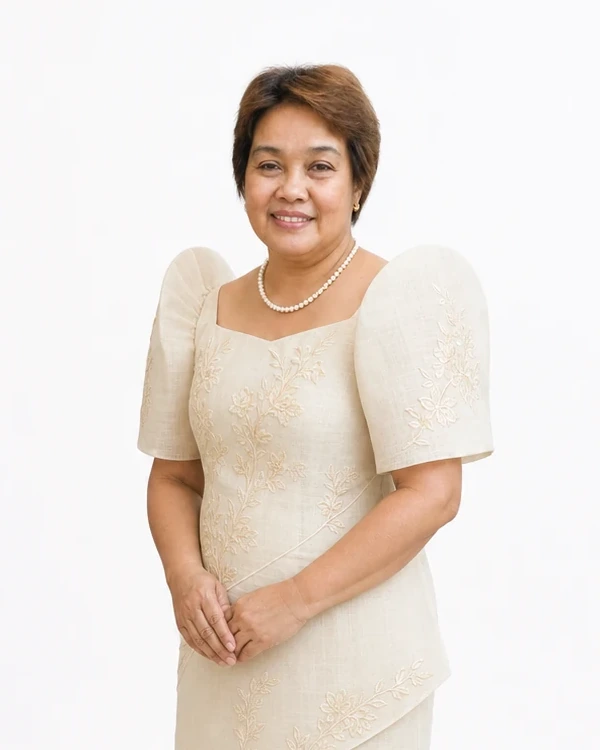 Half-body studio portrait of Sylvia Malicay Gealon smiling in an ivory Filipiniana and pearl necklace